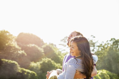 Man carrying girlfriend outdoors
