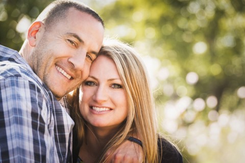 Smiling couple hugging outdoors