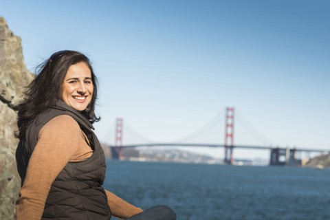 Mixed race woman smiling near Golden Gate Bridge view