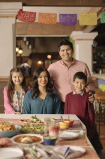 Portrait of smiling Hispanic family in restaurant