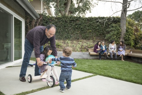 Boy and girl playing with grandfather