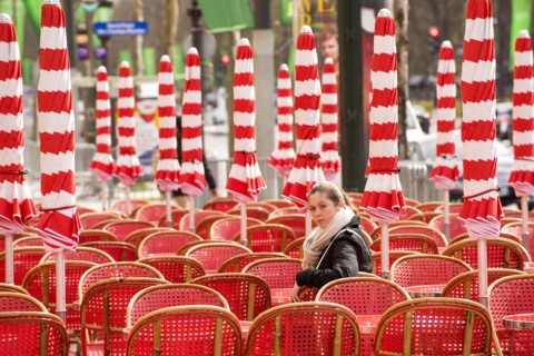 Girl sitting in red chair looking over shoulder