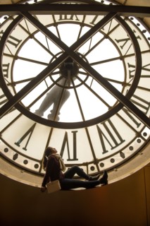 Girl sitting in clock window