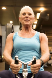 Smiling older woman working out in gymnasium