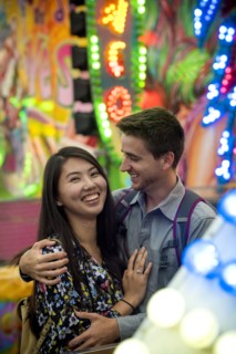 Smiling couple hugging in amusement park
