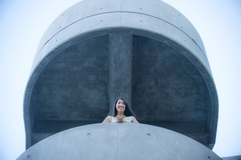 Low angle view of businesswoman leaning on balcony