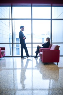 Businessman and businesswoman talking in office lounge