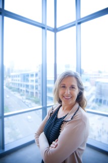 Portrait of smiling Caucasian businesswoman posing near window