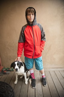 Portrait of Caucasian boy standing with dog
