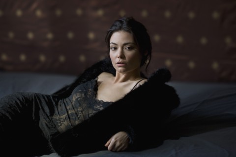 Serious Hispanic woman in fur coat