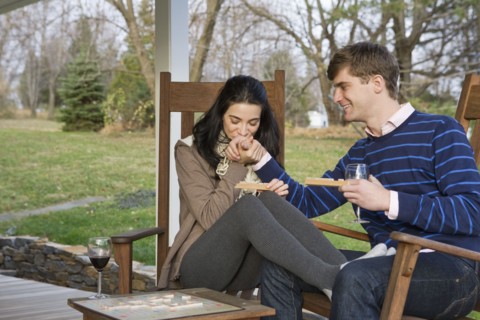 Caucasian couple playing scrabble on porch