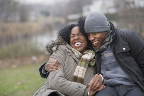 Couple laughing together outdoors