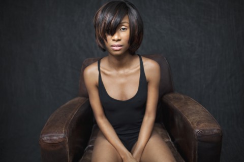 Black woman sitting in leather armchair