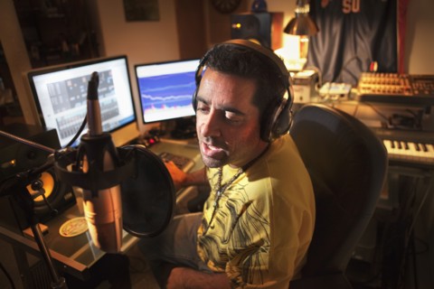 Caucasian man working in music studio