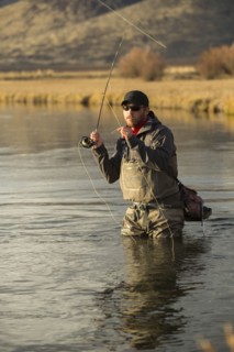 Fisherman casting in river
