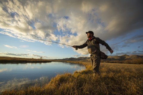 Fisherman casting in river
