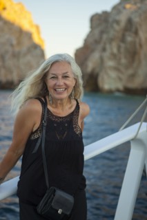 Older Caucasian woman smiling on boat