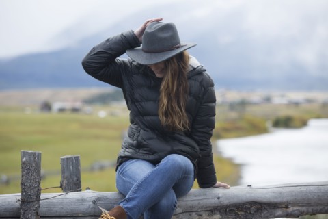 Caucasian woman sitting at rural river