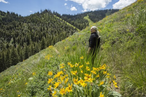 Caucasian woman walking on remote hillside