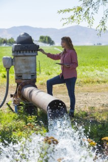Caucasian farmer checking water pump