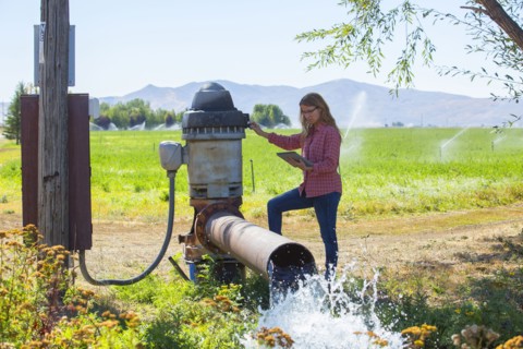 Caucasian farmer checking water pump