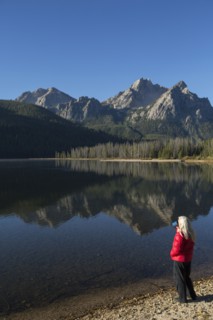 Caucasian woman admiring mountain and lake