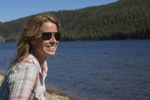 Caucasian woman sitting at remote river