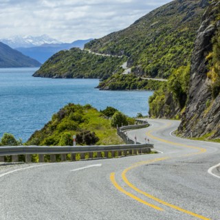 Highway on remote mountains near lake