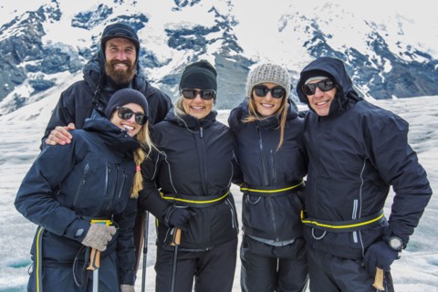 Caucasian cross-country skiers smiling in snowy landscape