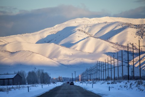 Snowy mountains over road in remote landscape