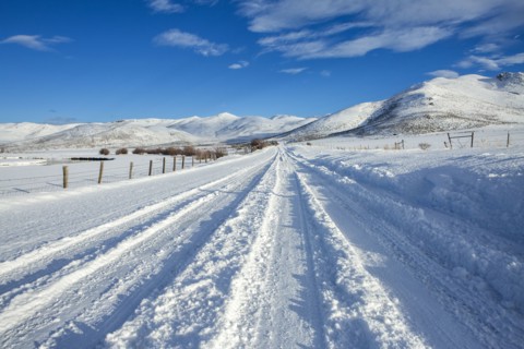 Tire tracks on snowy remote road