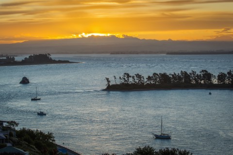 Aerial view of boats sailing near island sandbar