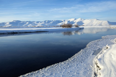 Still river in snowy remote landscape