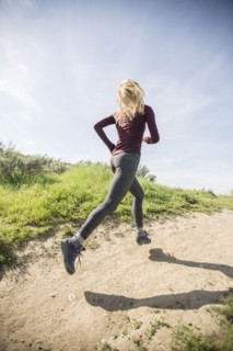 Caucasian woman running on dirt path