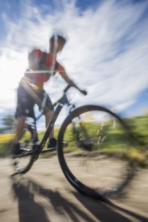 Blurred view of man riding mountain bike