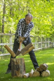 Caucasian man chopping wood