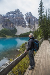 Caucasian man standing on boardwalk admiring mountain