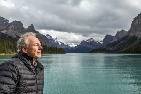Caucasian man standing near mountain lake