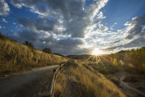 Sunset over distant mountain path