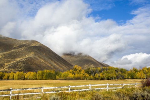 Fence and mountain under clouds