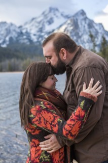 Caucasian couple kissing near river
