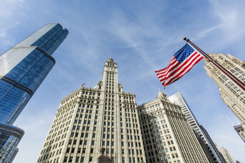 American flag and highrise buildings