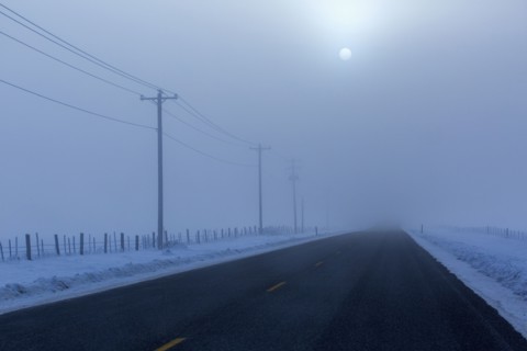Full moon over road in winter