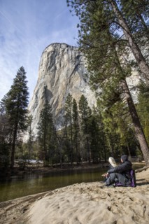 Caucasian couple sitting near river