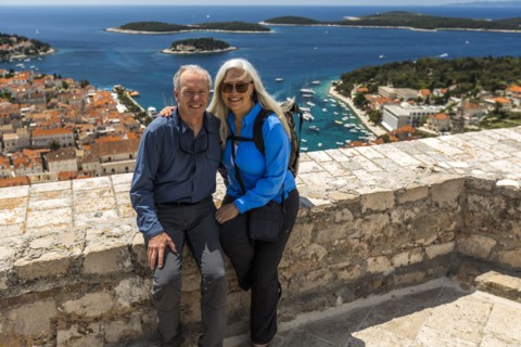 Caucasian couple posing near scenic view of ocean