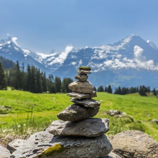 Rocks balancing in pile near mountains