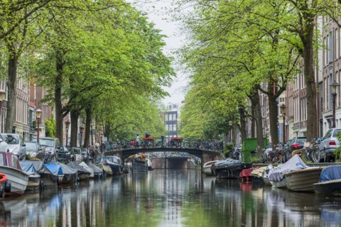 Boats near bridge over urban canal