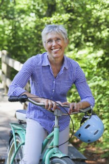 Portrait of Caucasian woman posing with bicycle