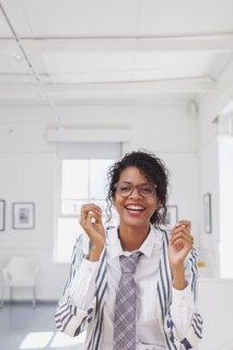 Mixed Race businesswoman laughing
