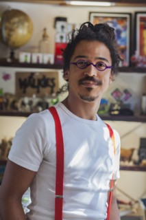 Serious mixed race man wearing suspenders